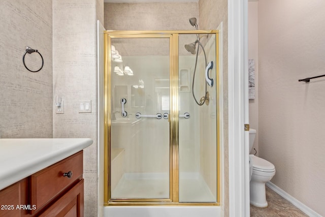 bathroom featuring a shower with door and toilet