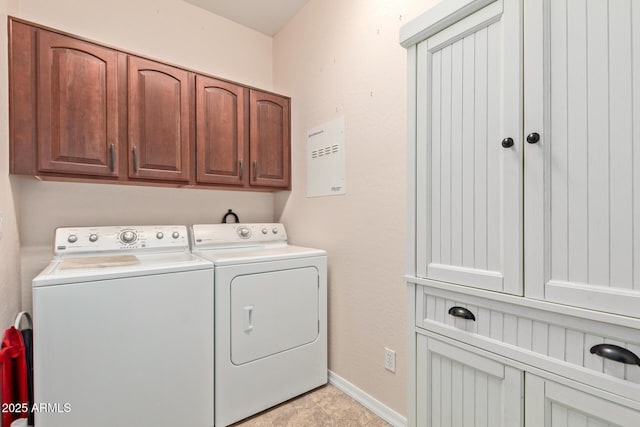 laundry room featuring cabinets and washing machine and clothes dryer