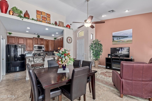 dining space featuring sink, high vaulted ceiling, and ceiling fan