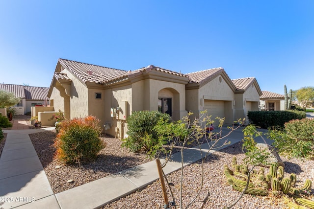 mediterranean / spanish-style home with a garage