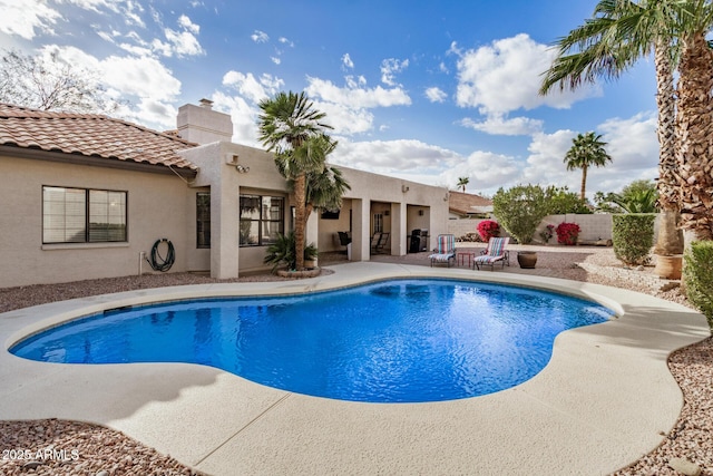 view of swimming pool with a patio area, fence, and a fenced in pool