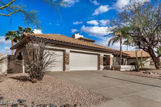 6118 E Star Valley St, Mesa, AZ 85215 - view of front facade with a garage, driveway, a chimney, and a tile roof