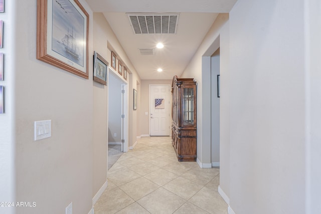 hall with light tile patterned floors