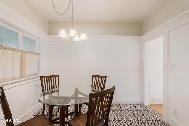 dining room featuring baseboards and a chandelier