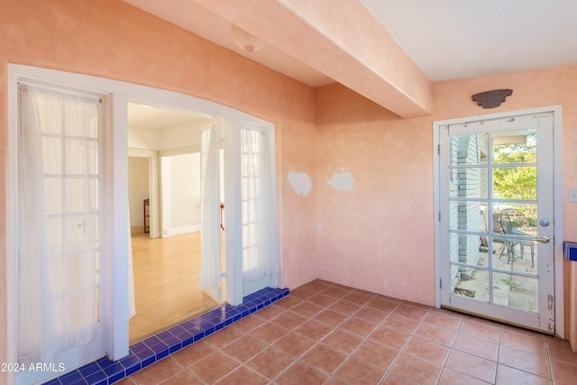 doorway to outside featuring tile patterned flooring