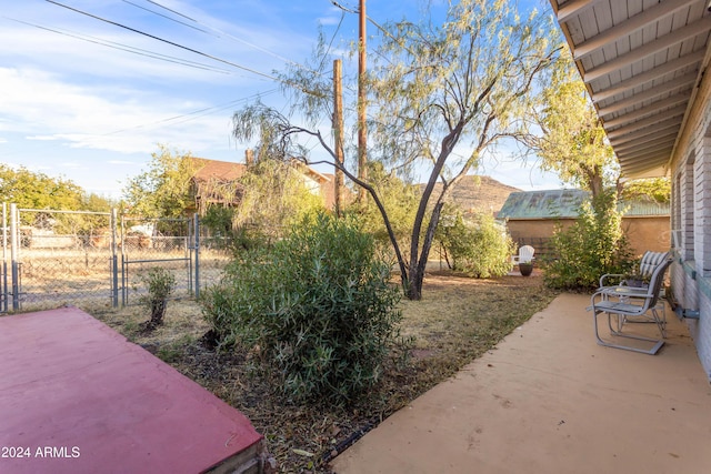 view of yard featuring fence, a patio, and a gate