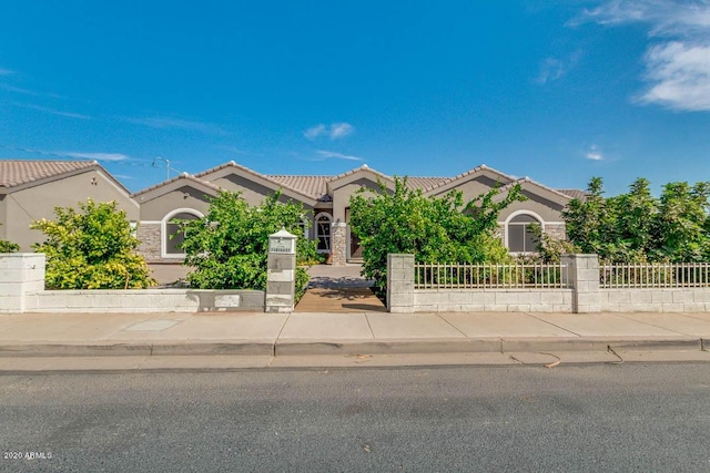 1101 S 4th St, Avondale, AZ 85323 - view of front of property with stucco siding, a fenced front yard, and a tiled roof