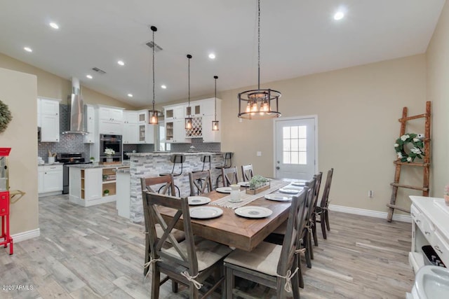 1101 S 4th St, Avondale, AZ 85323 - dining space with light wood-style flooring, vaulted ceiling, a chandelier, and recessed lighting