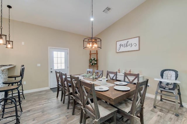 1101 S 4th St, Avondale, AZ 85323 - dining space with light wood-type flooring, lofted ceiling, and a chandelier