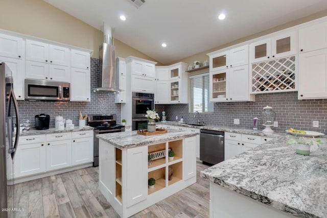 1101 S 4th St, Avondale, AZ 85323 - kitchen with appliances with stainless steel finishes, wall chimney range hood, lofted ceiling, white cabinets, and light wood-type flooring