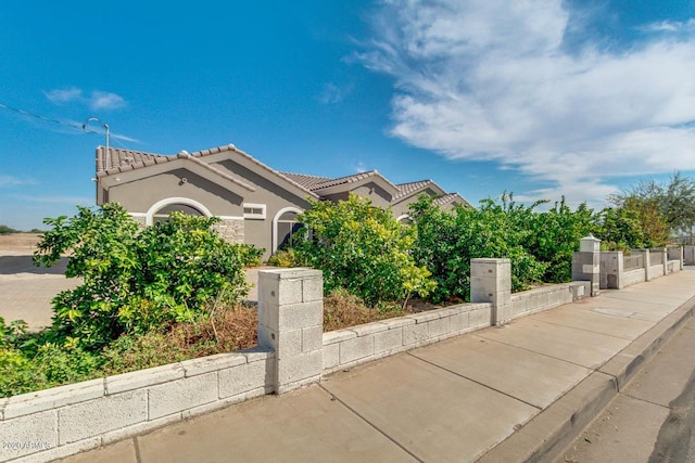 1101 S 4th St, Avondale, AZ 85323 - obstructed view of property with a tile roof and stucco siding