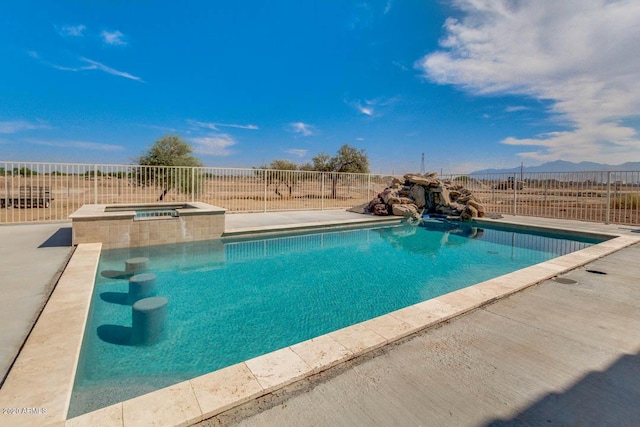 1101 S 4th St, Avondale, AZ 85323 - view of swimming pool featuring a mountain view, a patio area, and a pool with connected hot tub