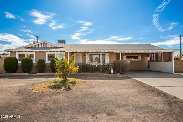 ranch-style house with concrete driveway, an attached carport, and brick siding