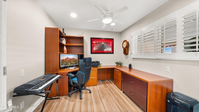 office area featuring built in desk, ceiling fan, and light hardwood / wood-style flooring