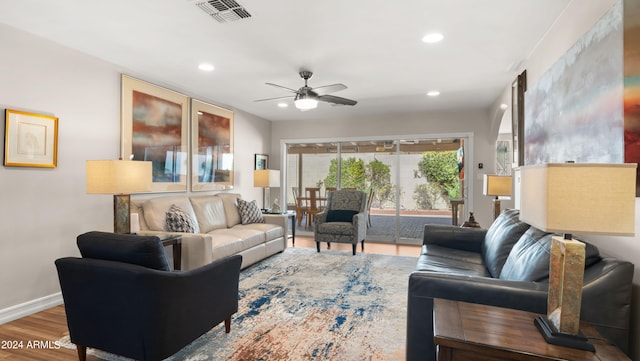 living room featuring ceiling fan and wood-type flooring