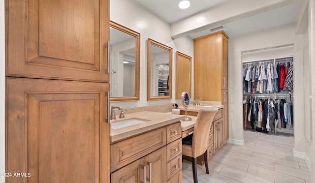 bathroom with vanity and hardwood / wood-style flooring