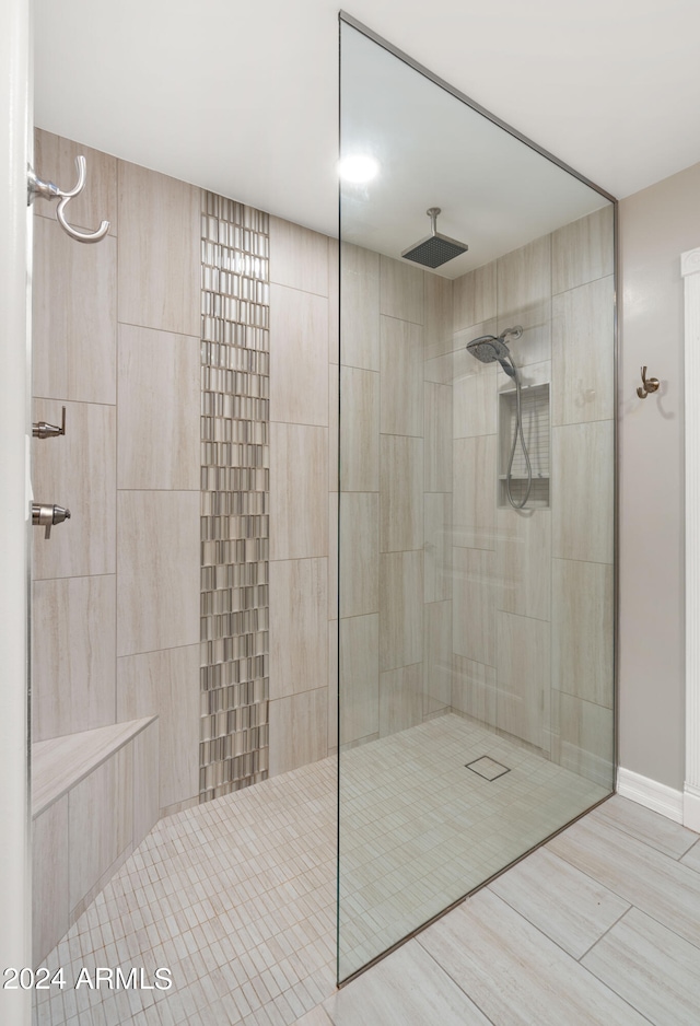 bathroom with a tile shower