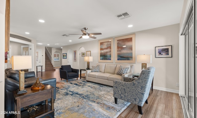 living room featuring hardwood / wood-style floors and ceiling fan