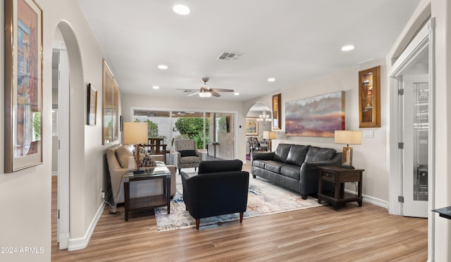 living room with hardwood / wood-style floors and ceiling fan