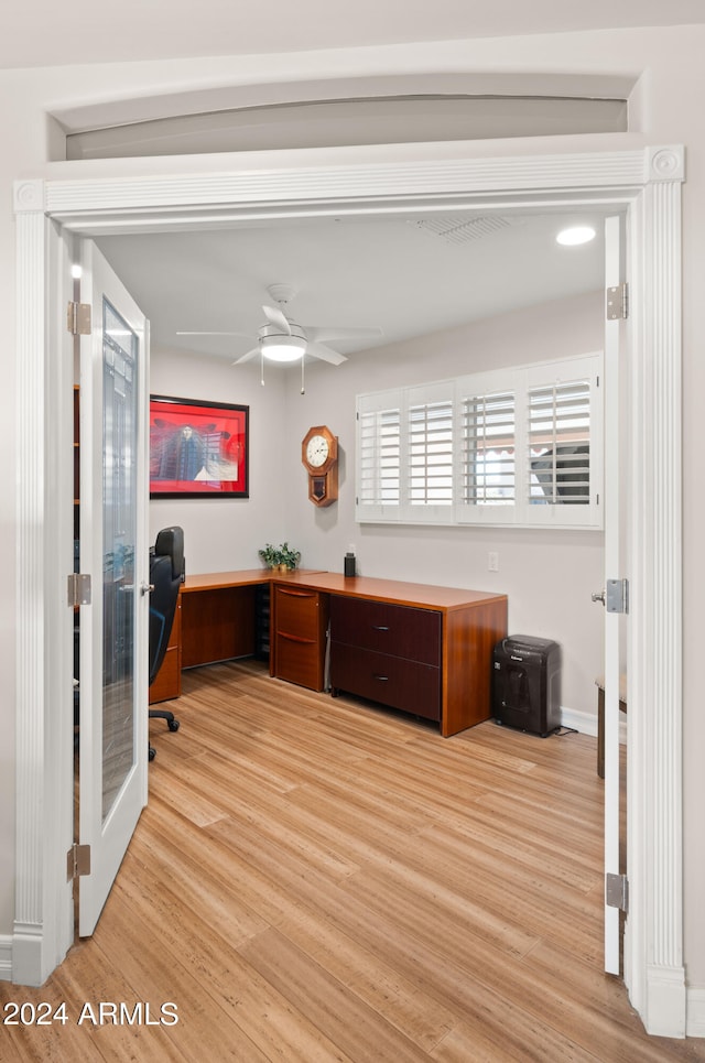 office with ceiling fan and light hardwood / wood-style floors