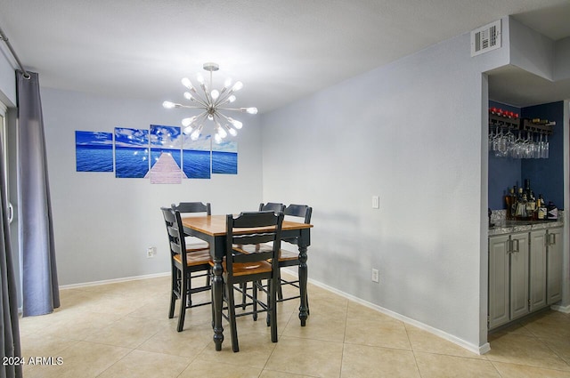 tiled dining space featuring a notable chandelier