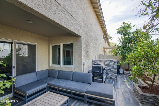 wooden deck featuring an outdoor living space and a patio