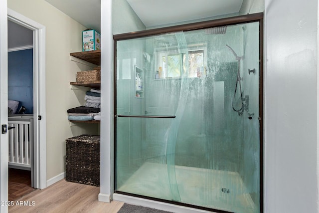 1024 E Saddle Mountain Rd, Phoenix, AZ 85086 - bathroom featuring wood finished floors, a shower stall, and baseboards