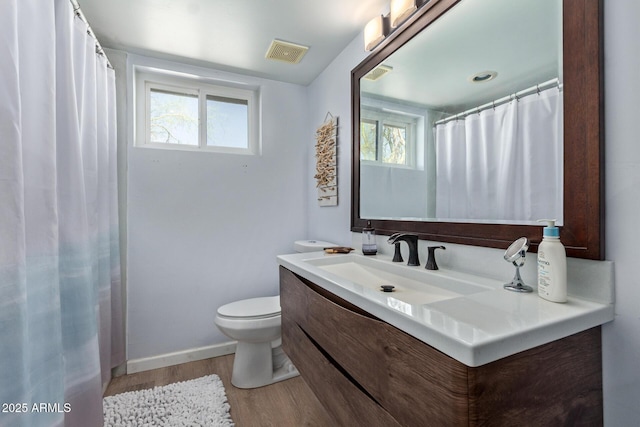 1024 E Saddle Mountain Rd, Phoenix, AZ 85086 - bathroom with toilet, wood finished floors, vanity, and healthy amount of natural light