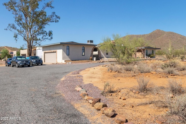 1024 E Saddle Mountain Rd, Phoenix, AZ 85086 - view of front of house with a mountain view, stucco siding, and an attached garage