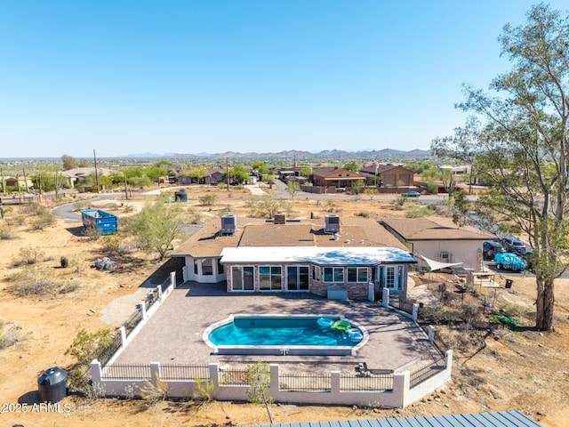 1024 E Saddle Mountain Rd, Phoenix, AZ 85086 - back of property featuring a fenced backyard, a patio, an outdoor pool, and a mountain view