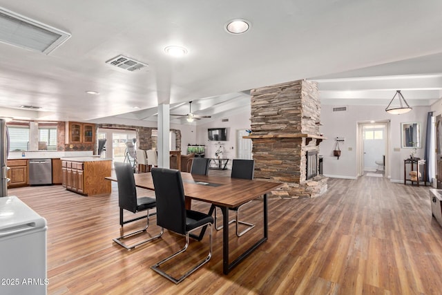 1024 E Saddle Mountain Rd, Phoenix, AZ 85086 - dining space featuring a fireplace, light wood finished floors, baseboards, and a ceiling fan