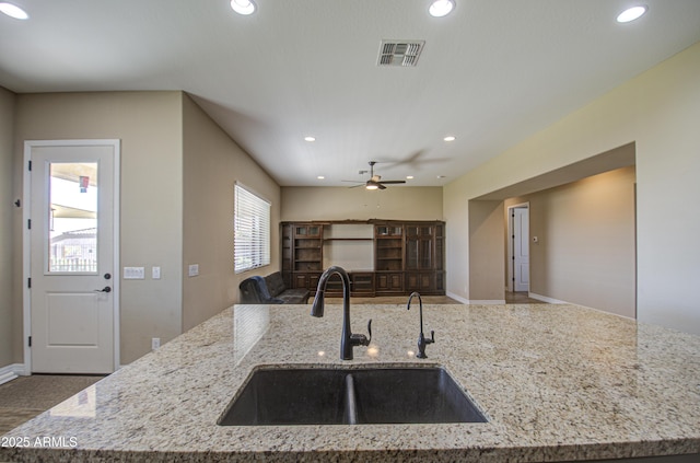 kitchen featuring open floor plan, a sink, visible vents, and recessed lighting