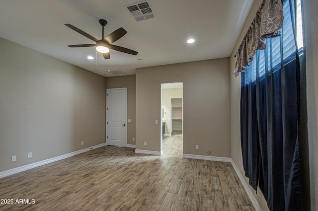 spare room with baseboards, visible vents, ceiling fan, wood finished floors, and recessed lighting