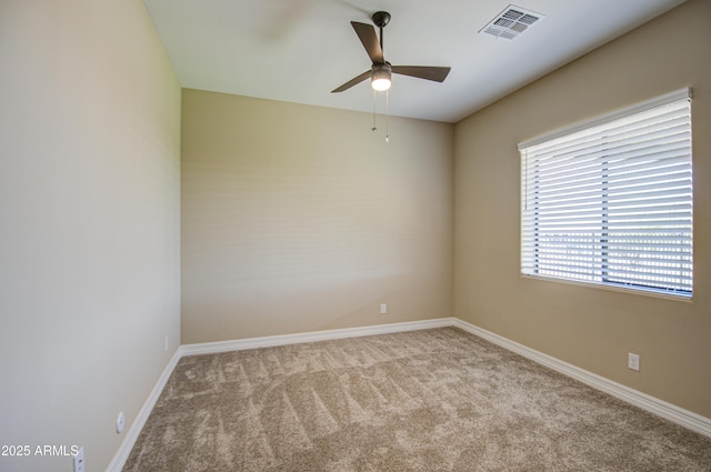 unfurnished room featuring carpet floors, baseboards, visible vents, and a ceiling fan