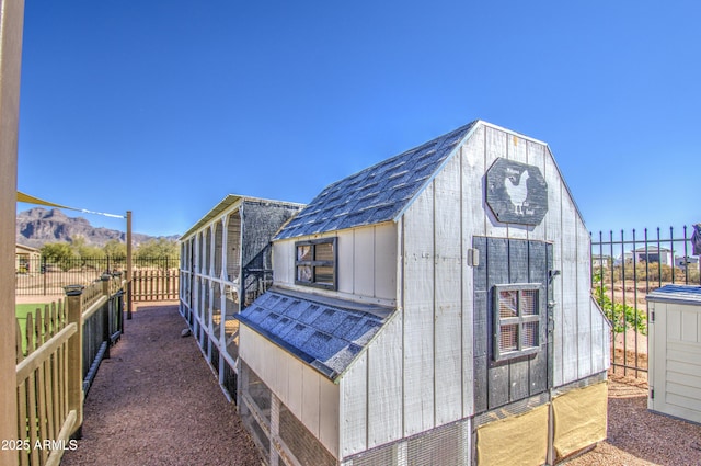 view of outdoor structure featuring an outbuilding and fence