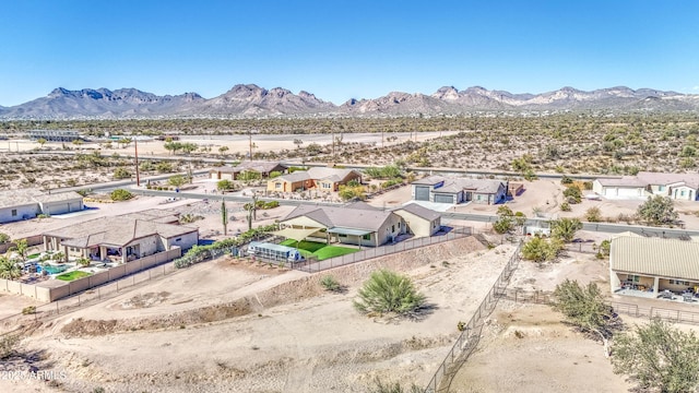 drone / aerial view with a residential view, a mountain view, and a desert view