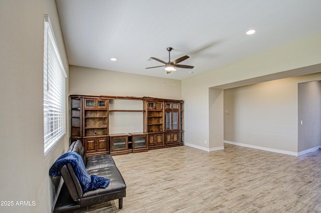 sitting room featuring baseboards, wood finished floors, and recessed lighting