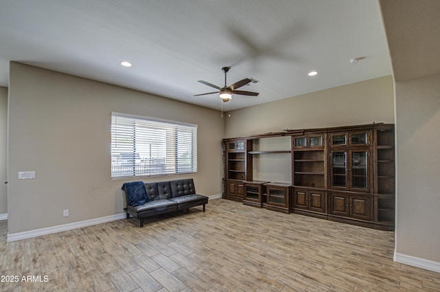 sitting room with light wood finished floors, baseboards, a ceiling fan, and recessed lighting