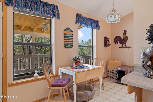 dining area featuring beamed ceiling, ceiling fan, and wood ceiling