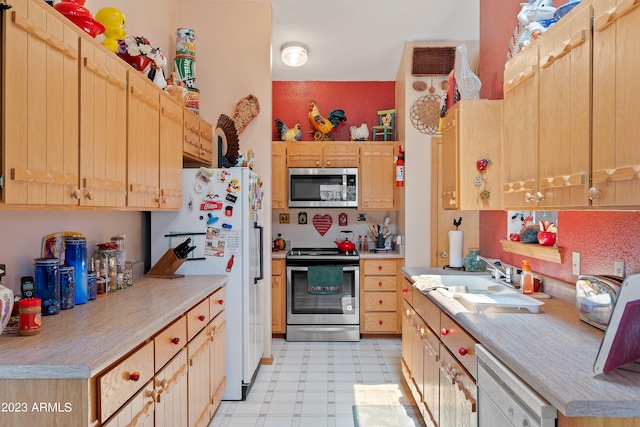 kitchen featuring light brown cabinets, sink, and appliances with stainless steel finishes