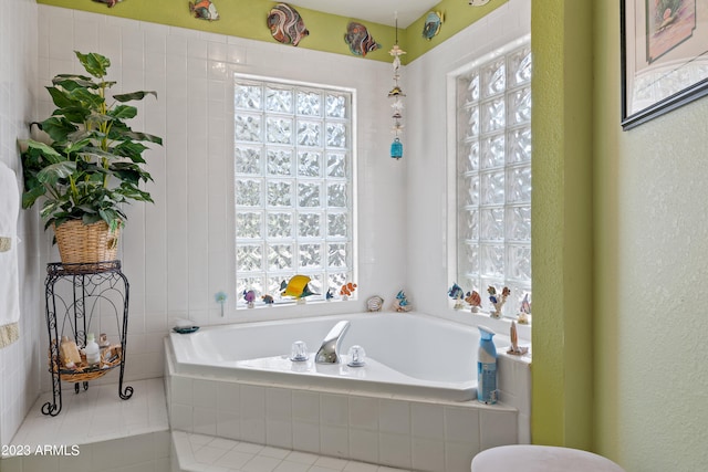 bathroom with a relaxing tiled tub