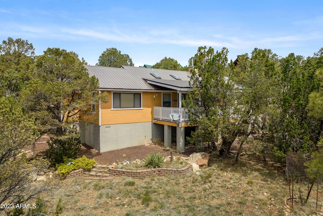 back of property featuring a wooden deck