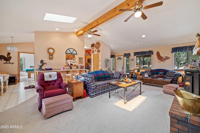 living room with light carpet, a skylight, ceiling fan, high vaulted ceiling, and beamed ceiling