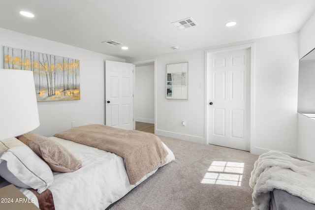 bedroom featuring light carpet