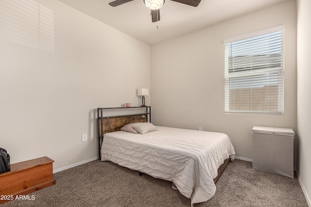 carpeted bedroom with a ceiling fan and baseboards