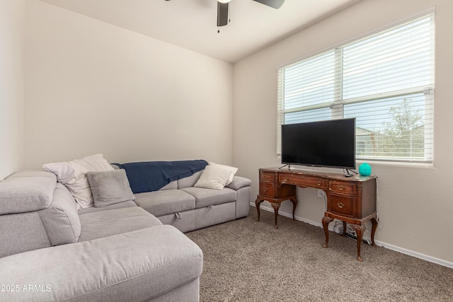 carpeted living room featuring ceiling fan and baseboards