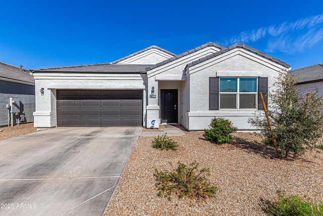 ranch-style house featuring a garage, driveway, a tiled roof, and stucco siding