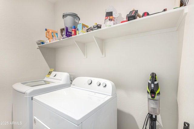 laundry room with laundry area and washing machine and clothes dryer