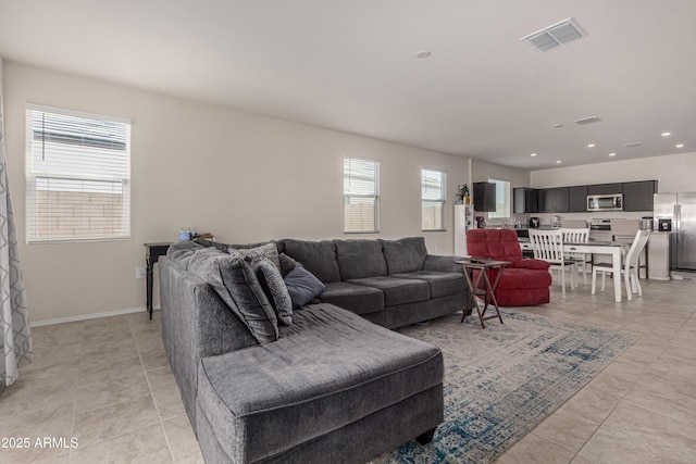 living area featuring recessed lighting, visible vents, baseboards, and light tile patterned floors