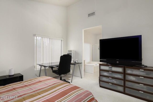 carpeted bedroom featuring visible vents and a towering ceiling